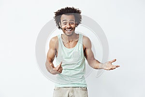 Happy and confident african man smiling pointing finger at himself inviting to a party over white background.