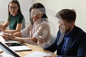 Happy confident businessman signing contract on meeting with partners