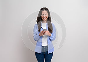 Happy confident businesswoman using social media over smart phone against isolated white background