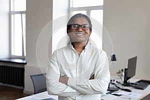 Happy confident Indian business man in glasses head shot portrait