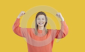 Happy confident lady smiling and flexing her arms illustrating Girl Power concept