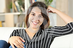 Happy confident woman at home looking at camera