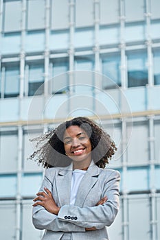 Happy confident young African American business woman in city vertical portrait.