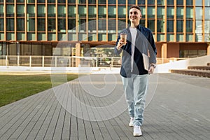 Happy confident young european man in casual enjoy lifestyle, with laptop and coffee cup in city
