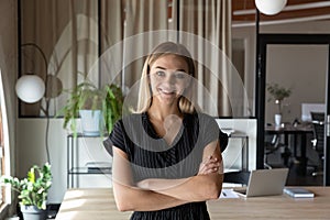 Happy confident young female business leader office portrait