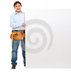 Happy construction worker holding blank billboard