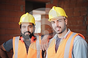 Happy Construction Workers Smiling At Camera In New Building
