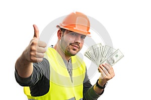 Happy constructor showing money making thumb-up gesture