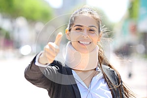 Happy convalescent businesswoman with thumbs up photo