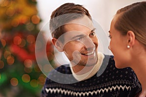 Happy, conversation and couple on a date on Christmas for romantic, holidays and love bonding. Smile, care and young man