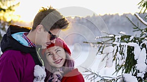 Happy coulple in love at sunny winter day. Winter, sport, holidays, relationship, love, xmas, lifestyle concept. Filmed