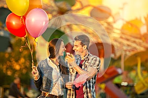 Happy couple in amusement park