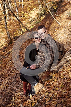 Happy couple in autumn forest.