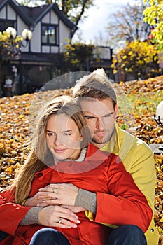 Happy Couple in Autumn Park. Fall. Young Family Having Fun Outdoors. Yellow Trees and Leaves. Laughing Man and Woman outside. Free