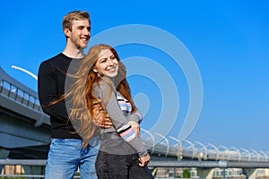 happy couple on the background of the sky and the bridge