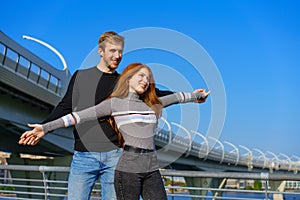 happy couple on the background of the sky and the bridge