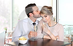 Happy couple at the bar drinking wine, love concept