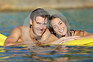 Happy couple bathing on the beach in summer vacation