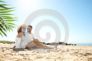 Happy couple on beach near sea. Honeymoon trip