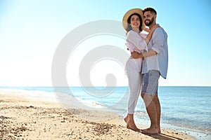 Happy couple on beach near sea. Honeymoon trip