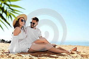 Happy couple on beach near sea. Honeymoon trip