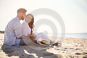 Happy couple on beach near sea. Honeymoon trip
