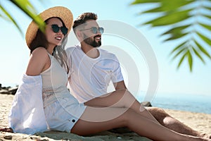 Happy couple on beach near sea. Honeymoon trip