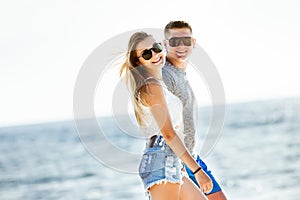 Happy couple beach walk sea photo