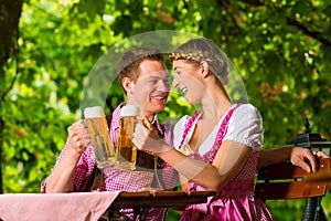 Happy Couple in Beer garden drinking beer