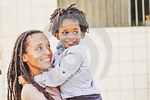 Happy couple black african skin people mother and son young together have fun and enjoy the outdoor leisure activity in the city