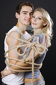 Happy couple bound with ropes