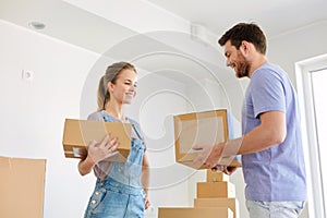 Happy couple with boxes moving to new home