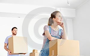 Happy couple with boxes moving to new home