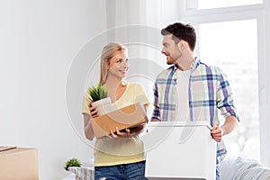 Happy couple with boxes moving to new home