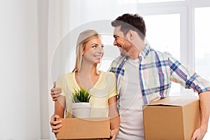 Happy couple with boxes moving to new home