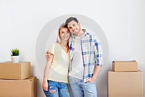 Happy couple with boxes moving to new home