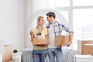 Happy couple with boxes moving to new home