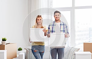 Happy couple with boxes moving to new home