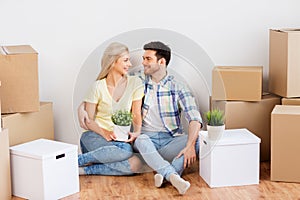 Happy couple with boxes moving to new home