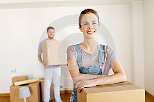 Happy couple with boxes moving to new home