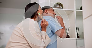 Happy couple, brushing teeth and laughing at bathroom in home for bad breath, oral health and wellness. Funny man, woman