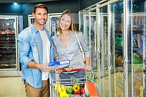Happy couple buying frozen food