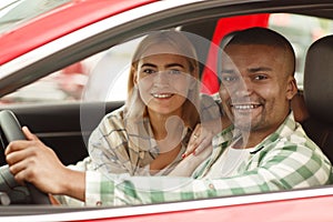 Happy couple buying new car together at the dealership