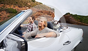 Happy couple, car and driving on road trip for travel, holiday weekend or outdoor vacation on street in nature. Young