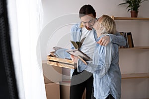 Happy couple with cardboard boxes in new house on moving day.Moving