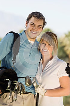 Happy Couple Carrying Golf Bag