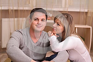 Happy couple in casual clothes having rest at home.