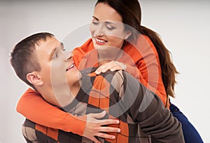 Happy couple in casual clothes on a light grey background