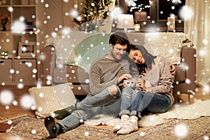 Happy couple with cat at home