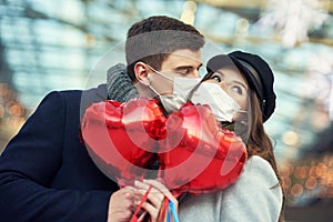 Happy couple celebrating Valentines Day in masks during covid-19 pandemic